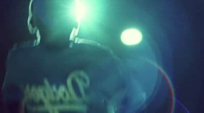 a blurry image of a person standing in the dark