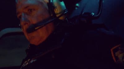 a man wearing a helmet in the dark
