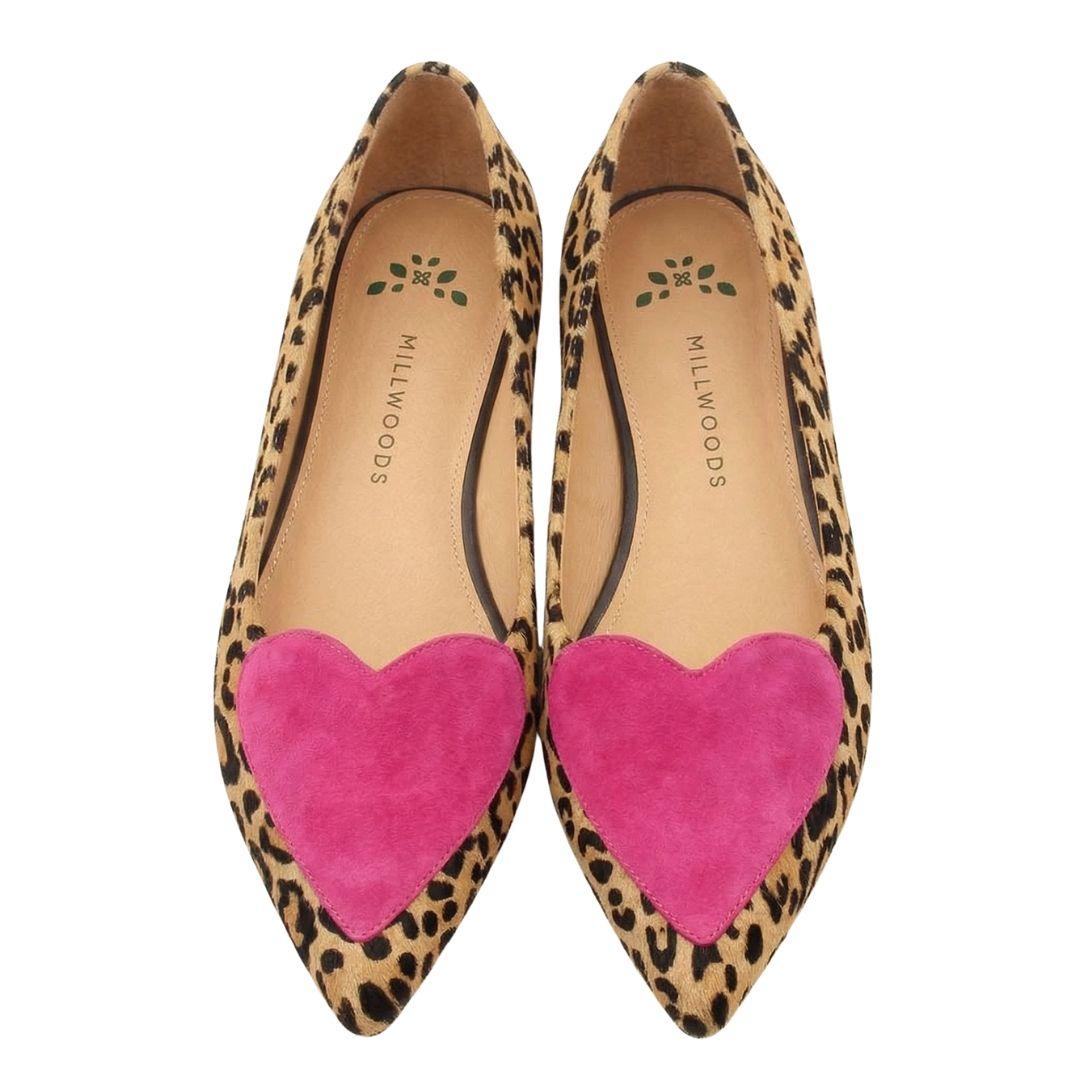 a pair of leopard print shoes with a pink heart