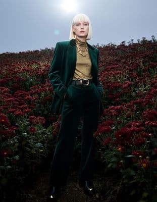 a woman standing in a field of flowers