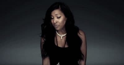 a woman in a black dress holding a cell phone