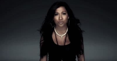 a woman in a black dress posing for a picture