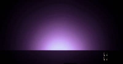 a dark room with a purple light in the middle