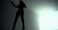 a silhouette of a woman jumping in the air