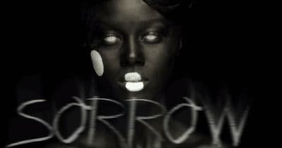 a black and white photo of a woman with her eyes open