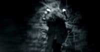 a man walking down a street at night