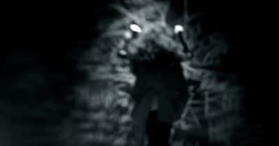 a man walking down a street at night
