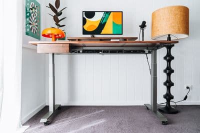 a desk with a lamp and a picture on it