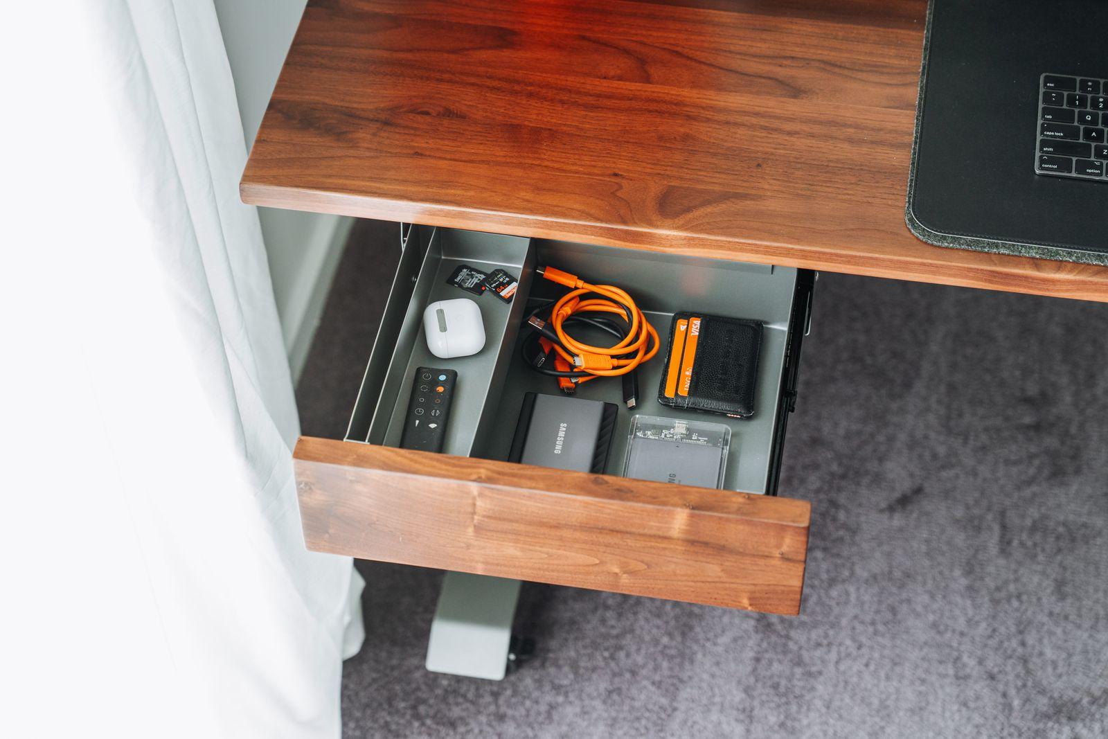 a laptop computer sitting on top of a wooden desk