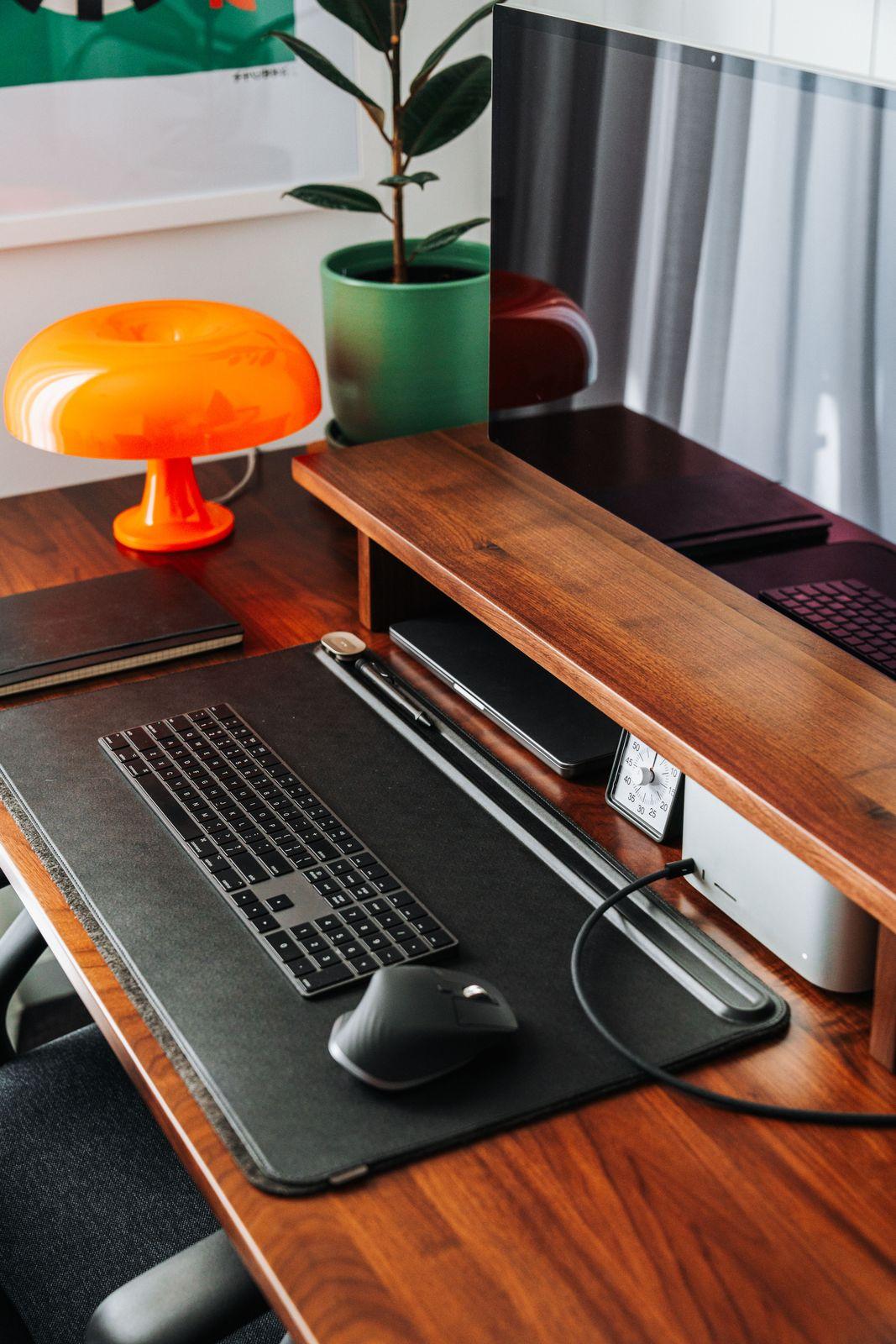 a laptop computer sitting on top of a wooden desk