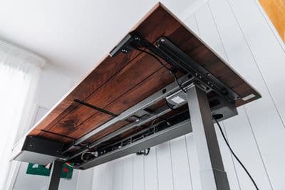 a wooden table with a metal frame underneath it