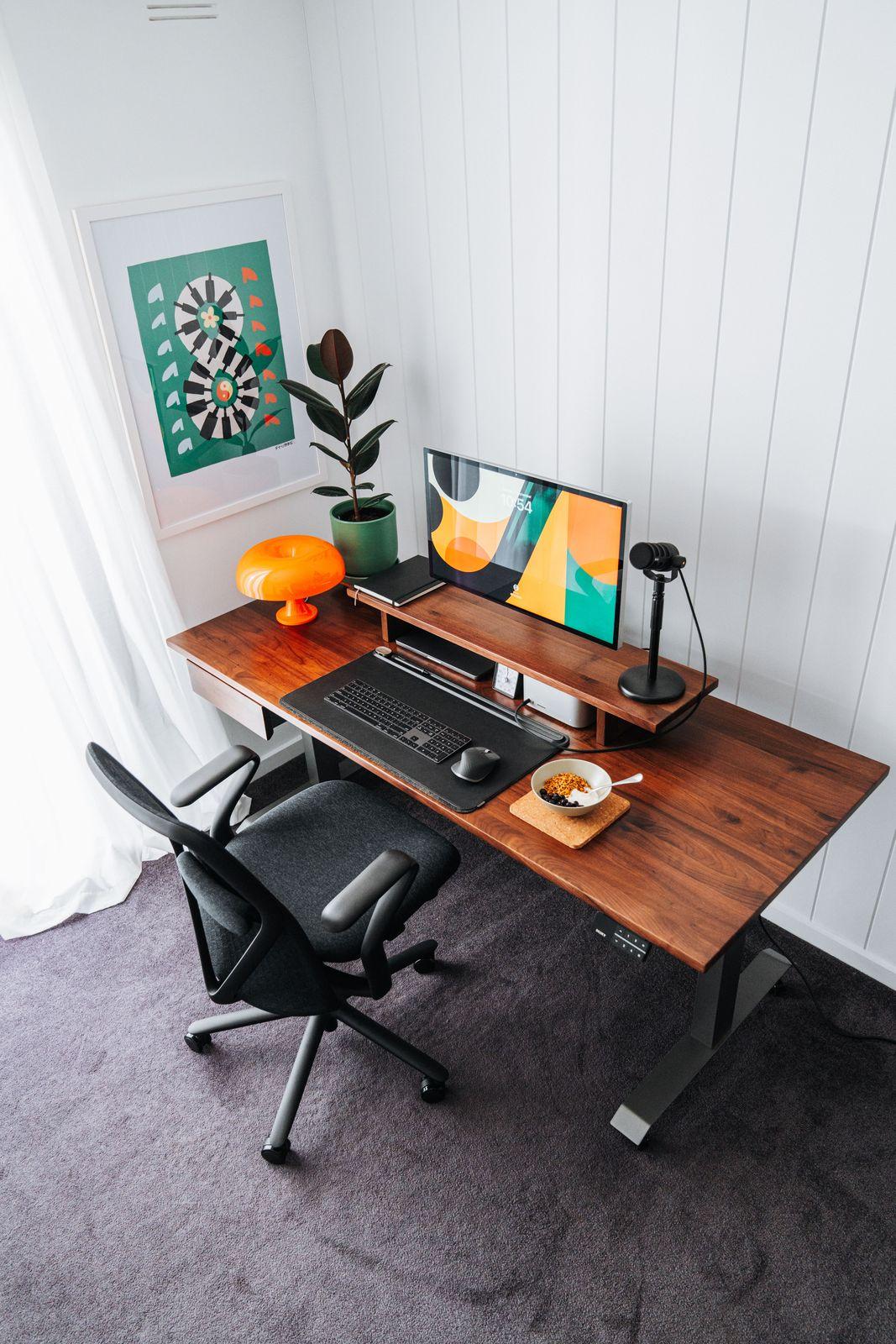 a computer desk with a computer on top of it