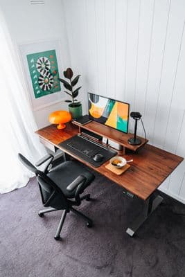 a computer desk with a computer on top of it
