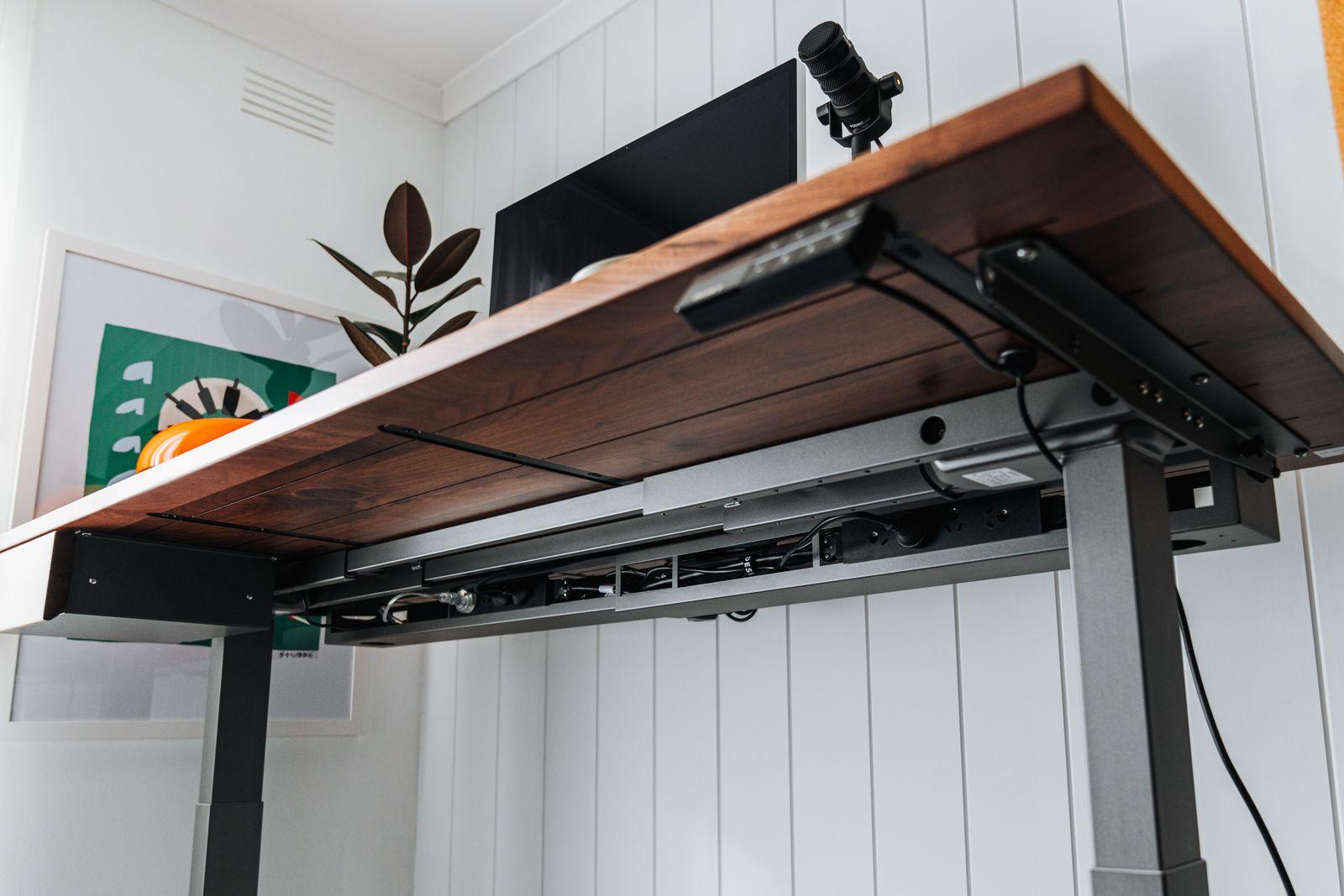 a computer desk with a monitor on top of it