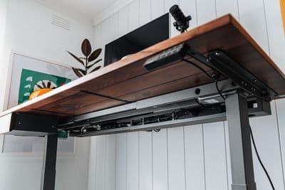 a computer desk with a monitor on top of it