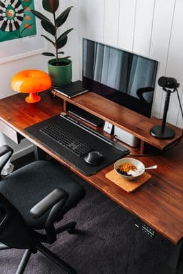 a desk with a computer and a bowl of cereal