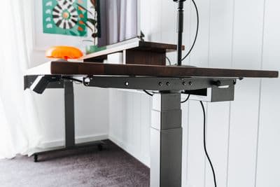 a desk with a laptop on it and a lamp on top of it