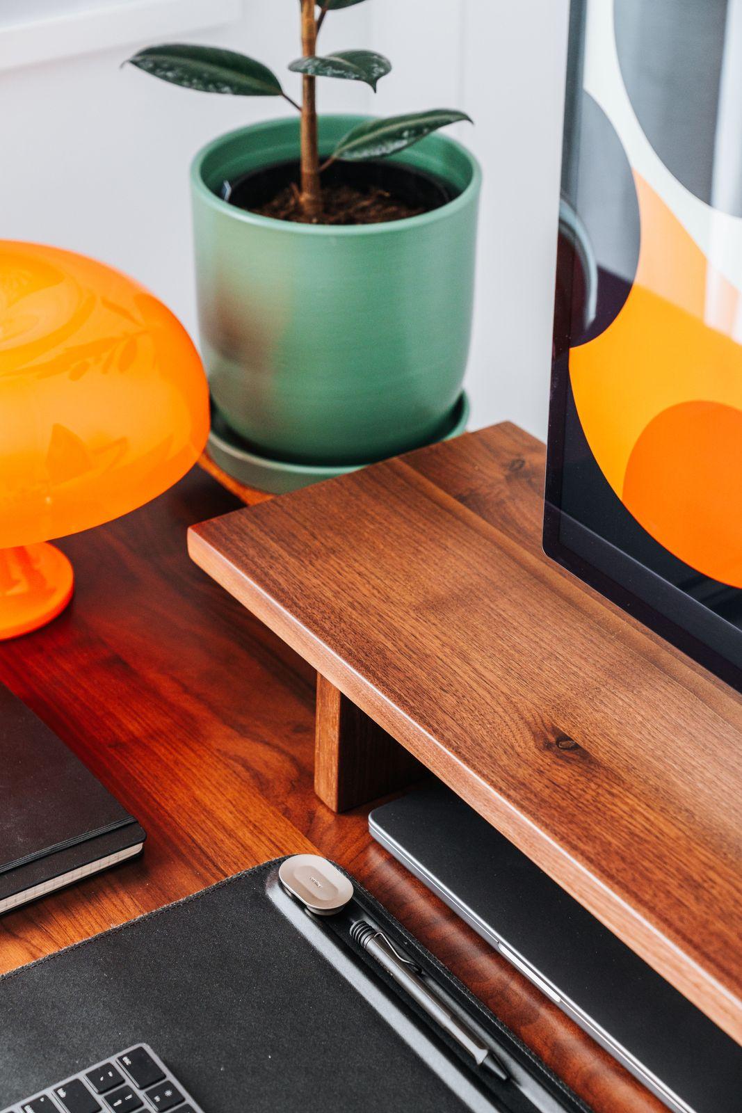 a desk with a laptop and a plant on it