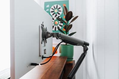 a laptop computer sitting on top of a wooden desk