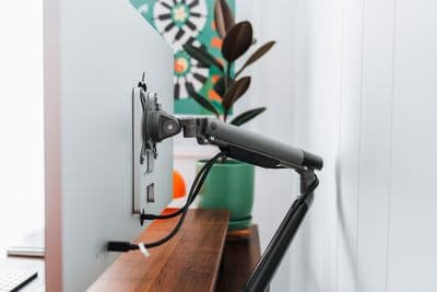 a desk with a laptop and a monitor on it