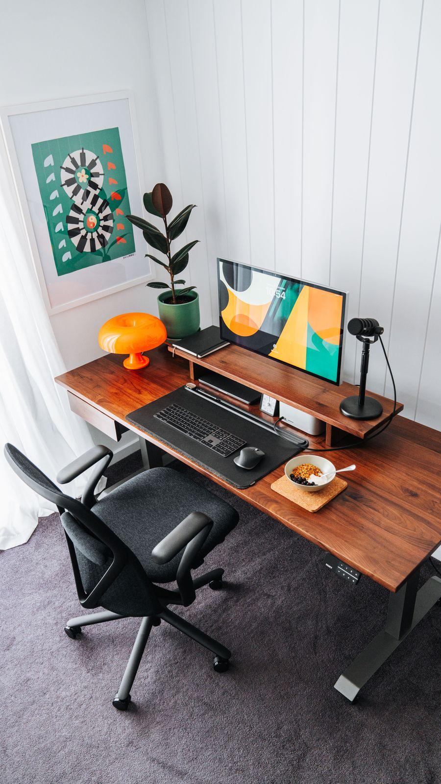 a computer desk with a monitor, keyboard and mouse