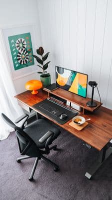 a computer desk with a monitor, keyboard and mouse