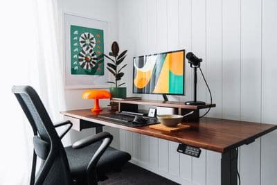 a desk with a computer and a chair