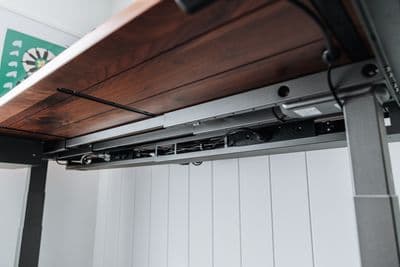 a close up of a metal shelf with a wooden top