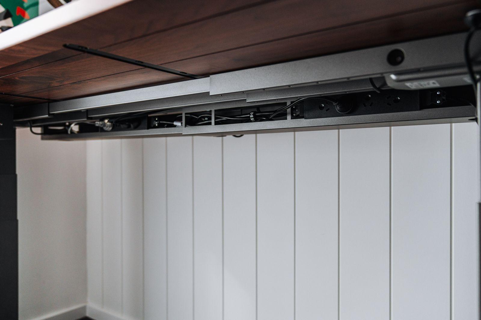 a kitchen with white walls and a wooden ceiling