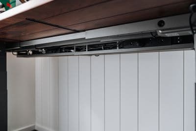 a kitchen with white walls and a wooden ceiling