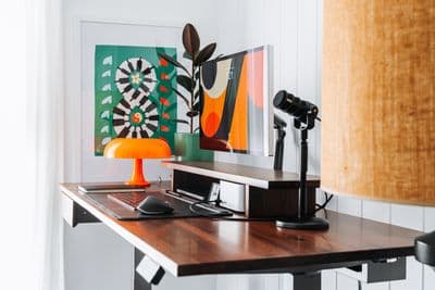 a desk with a lamp and a laptop on it