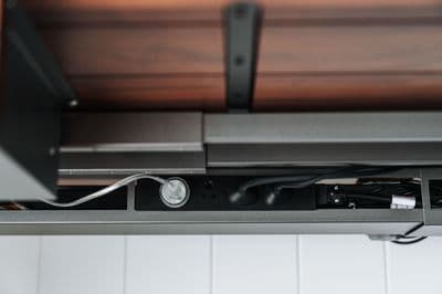 a close up of a metal shelf with wires attached to it