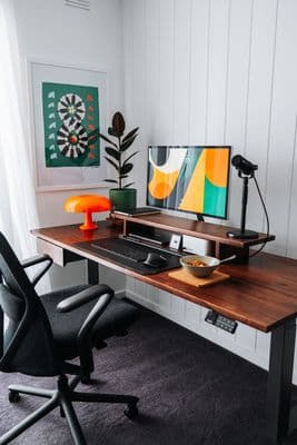 a desk with a computer on top of it
