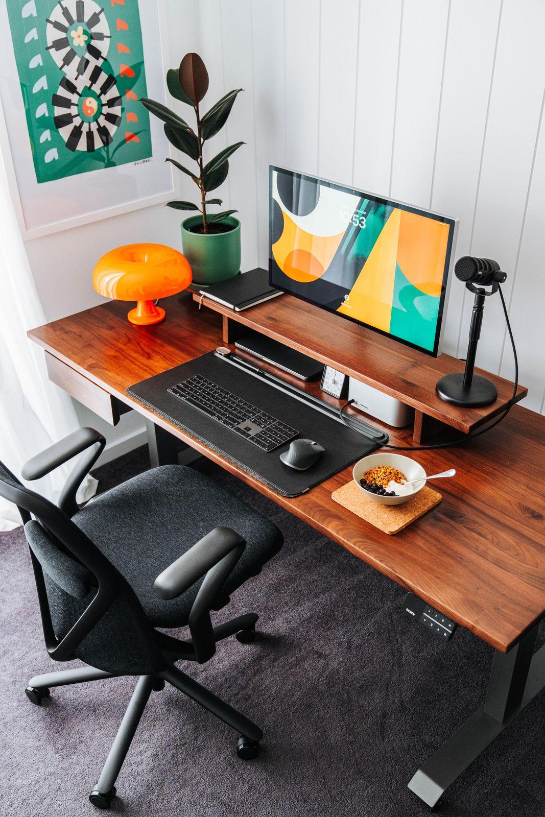 a computer desk with a monitor, keyboard and mouse