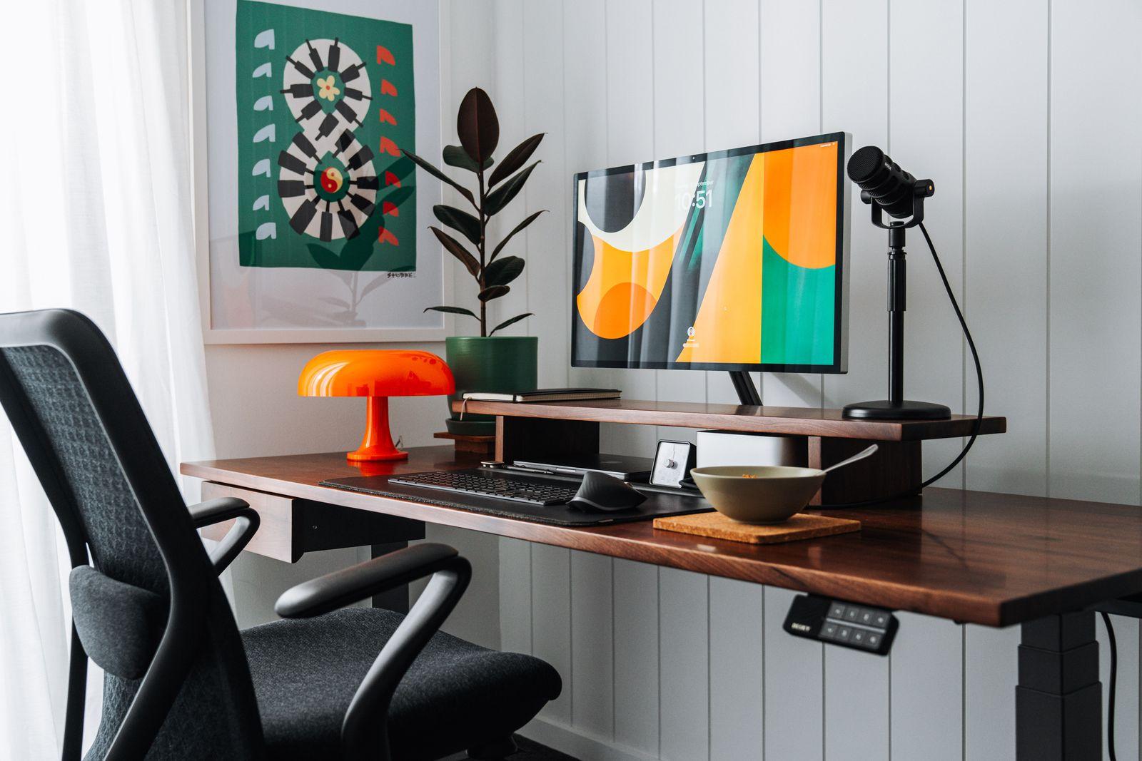 a desk with a computer and a chair