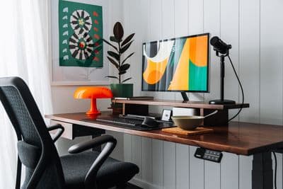 a desk with a computer and a chair
