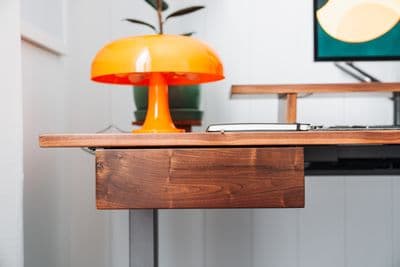 a desk with a lamp and a laptop on it