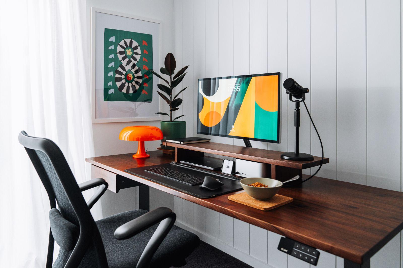 a desk with a computer and a chair