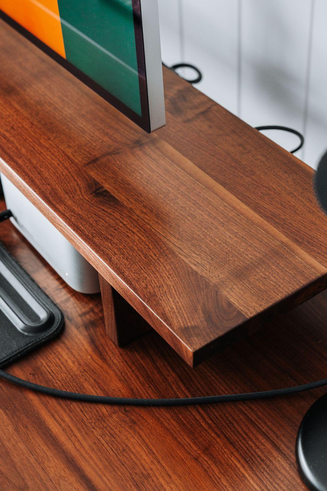 a computer monitor sitting on top of a wooden desk