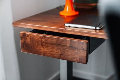 a wooden desk with a laptop on top of it