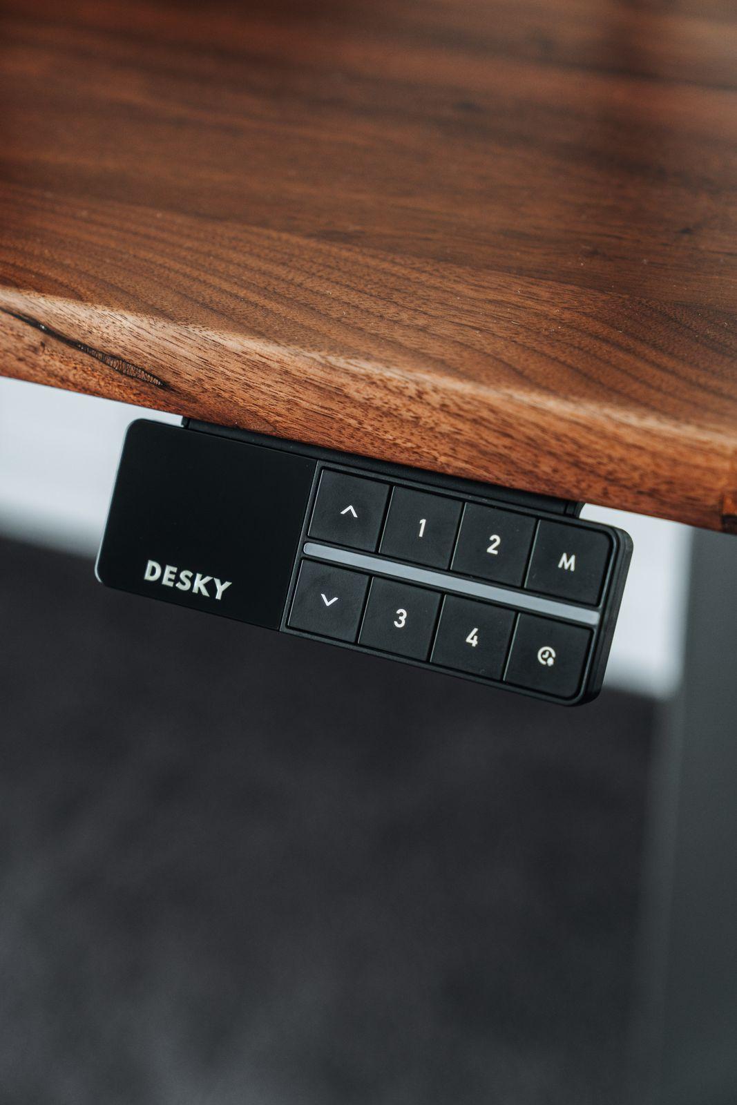 a close up of a remote control on a wooden table