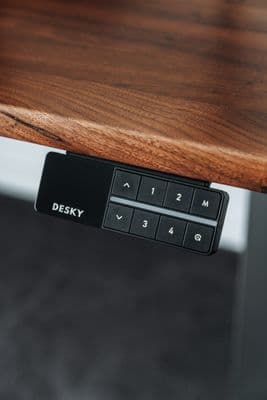 a close up of a remote control on a wooden table