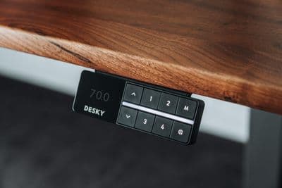 a close up of a wooden table with a remote control
