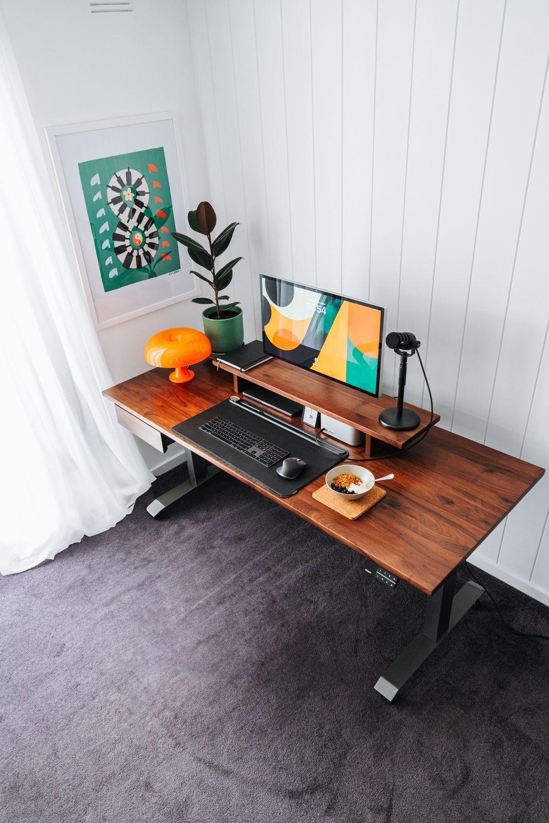 a computer desk with a monitor, keyboard and mouse