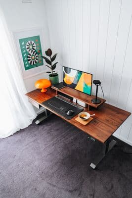 a computer desk with a monitor, keyboard and mouse