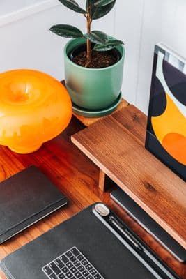 a laptop computer sitting on top of a wooden desk