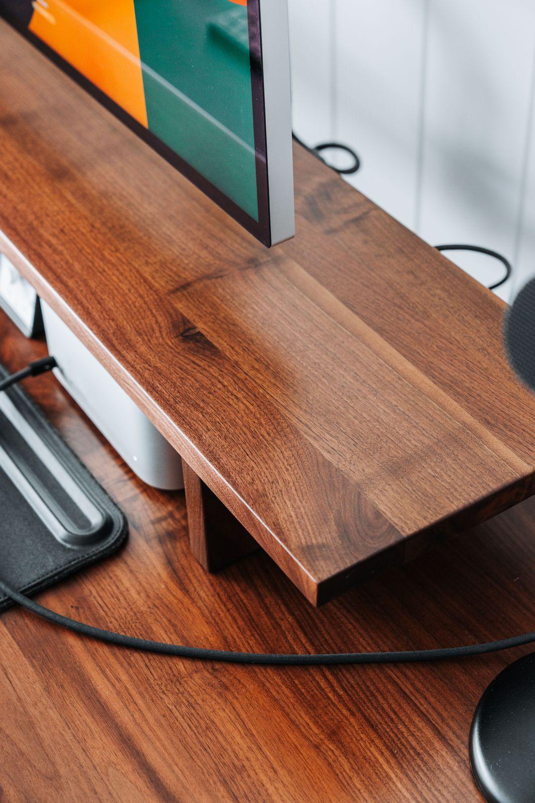 a computer monitor sitting on top of a wooden desk