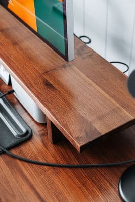 a computer monitor sitting on top of a wooden desk