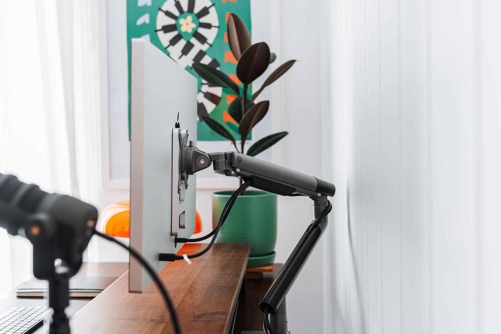 a desk with a laptop and a microphone