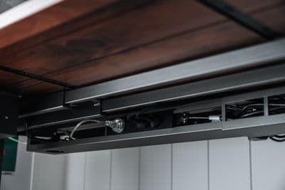 a close up of a metal and wood shelf